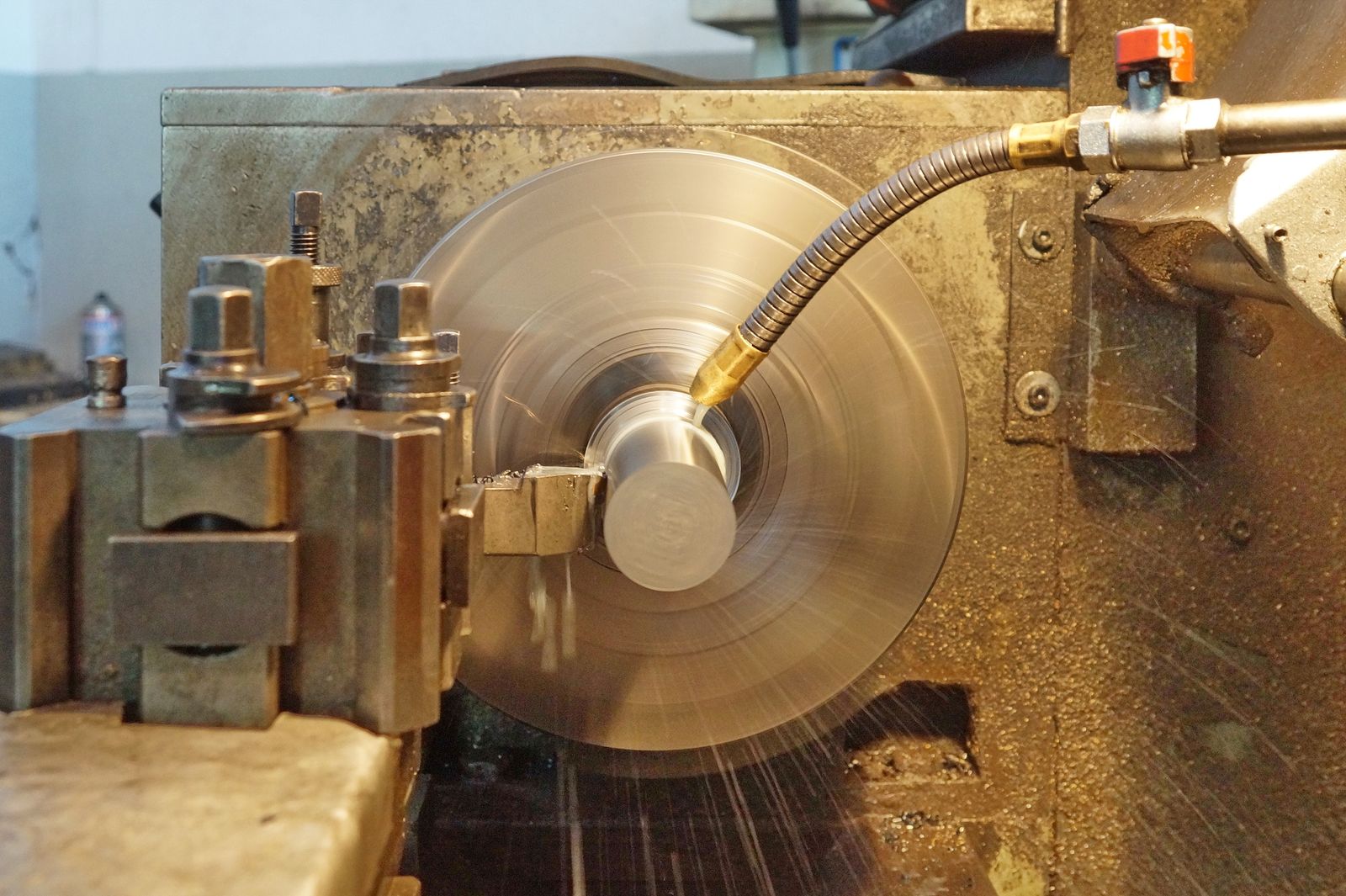 Steel round bar being turned on a CNC lathe